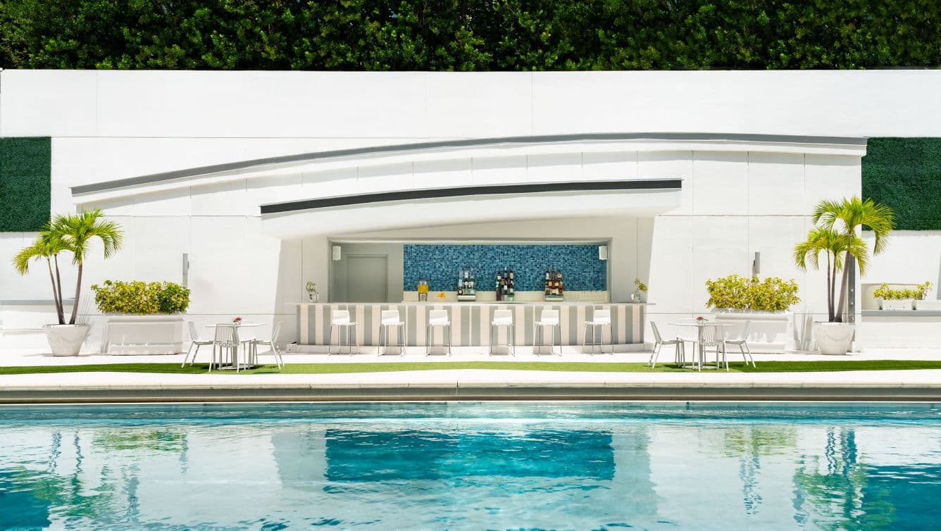 The hotel's outdoor pool deck, loungers arranged along the water beneath the Brickell skyline.